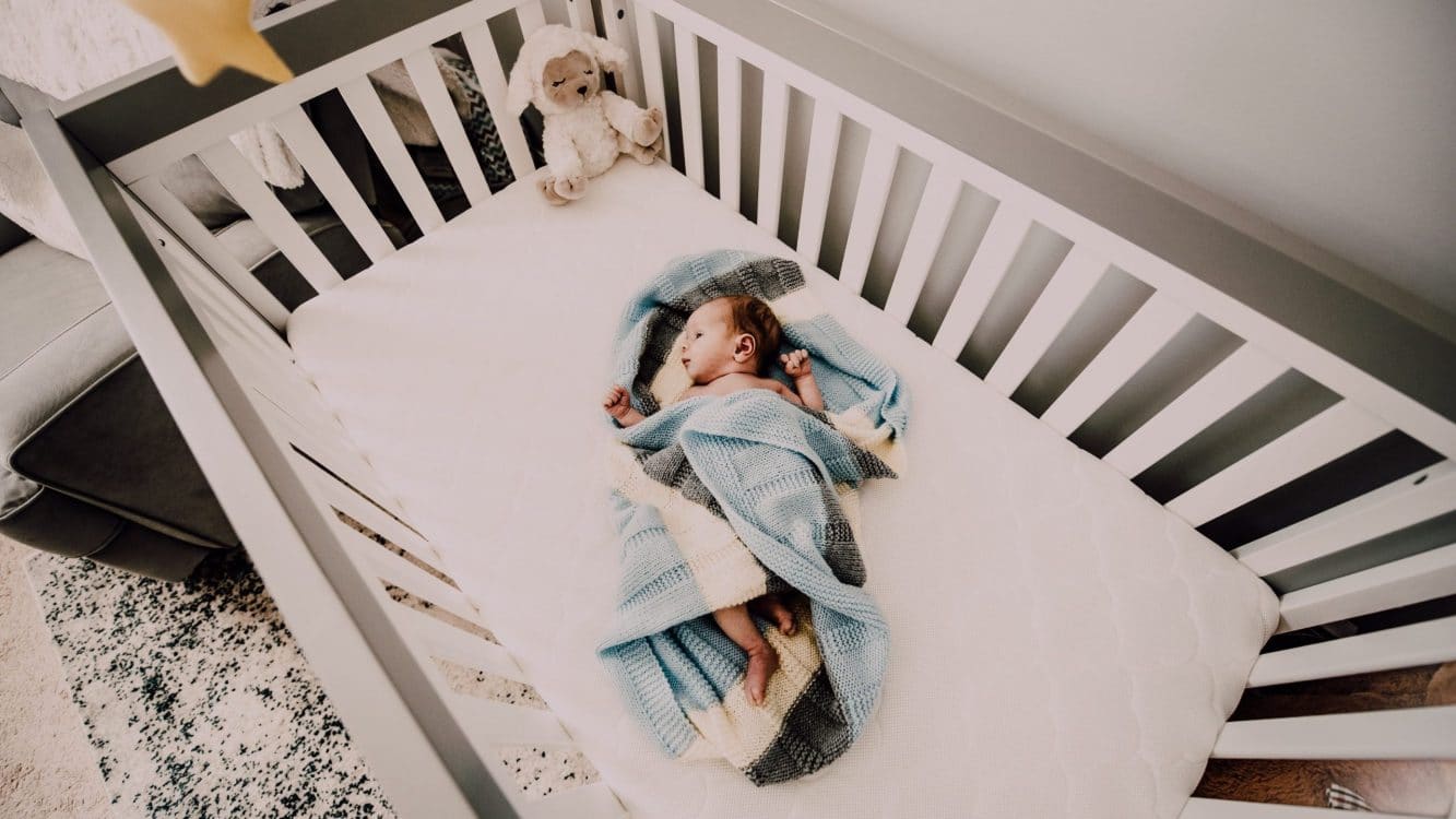 Best Convertible Baby Cribs- picture of baby in a convertible crib